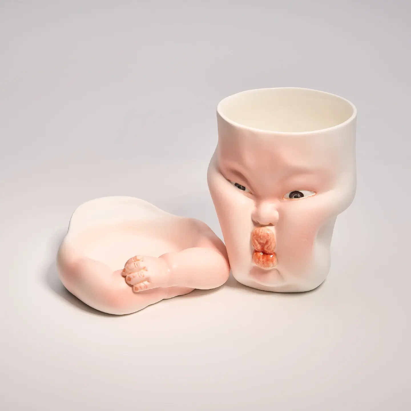 Whimsical Ceramic Cheeky Pinch Mug-Unique & Thoughtful Gifts for Meaningful Moments Whimsical Ceramic Cheeky Pinch Mug-this hand-painted mug features a chubby cheek being pinched in a gesture of affection