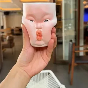 Whimsical Ceramic Cheeky Pinch Mug-this hand-painted mug features a chubby cheek being pinched in a gesture of affection