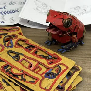 Strawberry Poison Dart Frog Paper Model-Bring the rainforest to your desk by assembling this vibrant, lifelike frog from 127 pieces of eco-friendly kraft paper